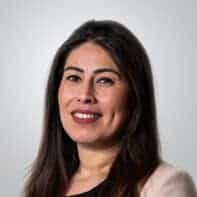 A woman with long hair and a blazer.