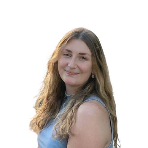 About us: A woman in a blue top, smiling for the camera.